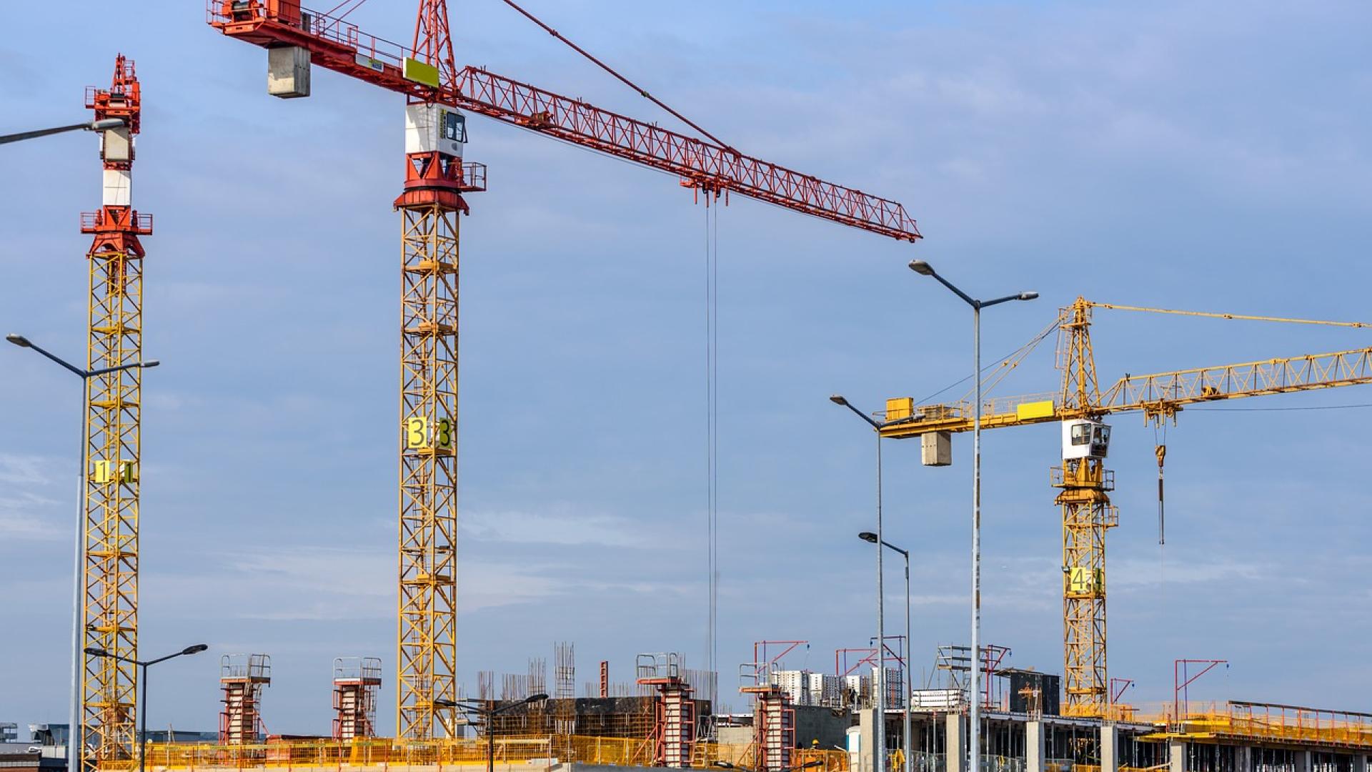 Building the lifts on big construction site with cranes