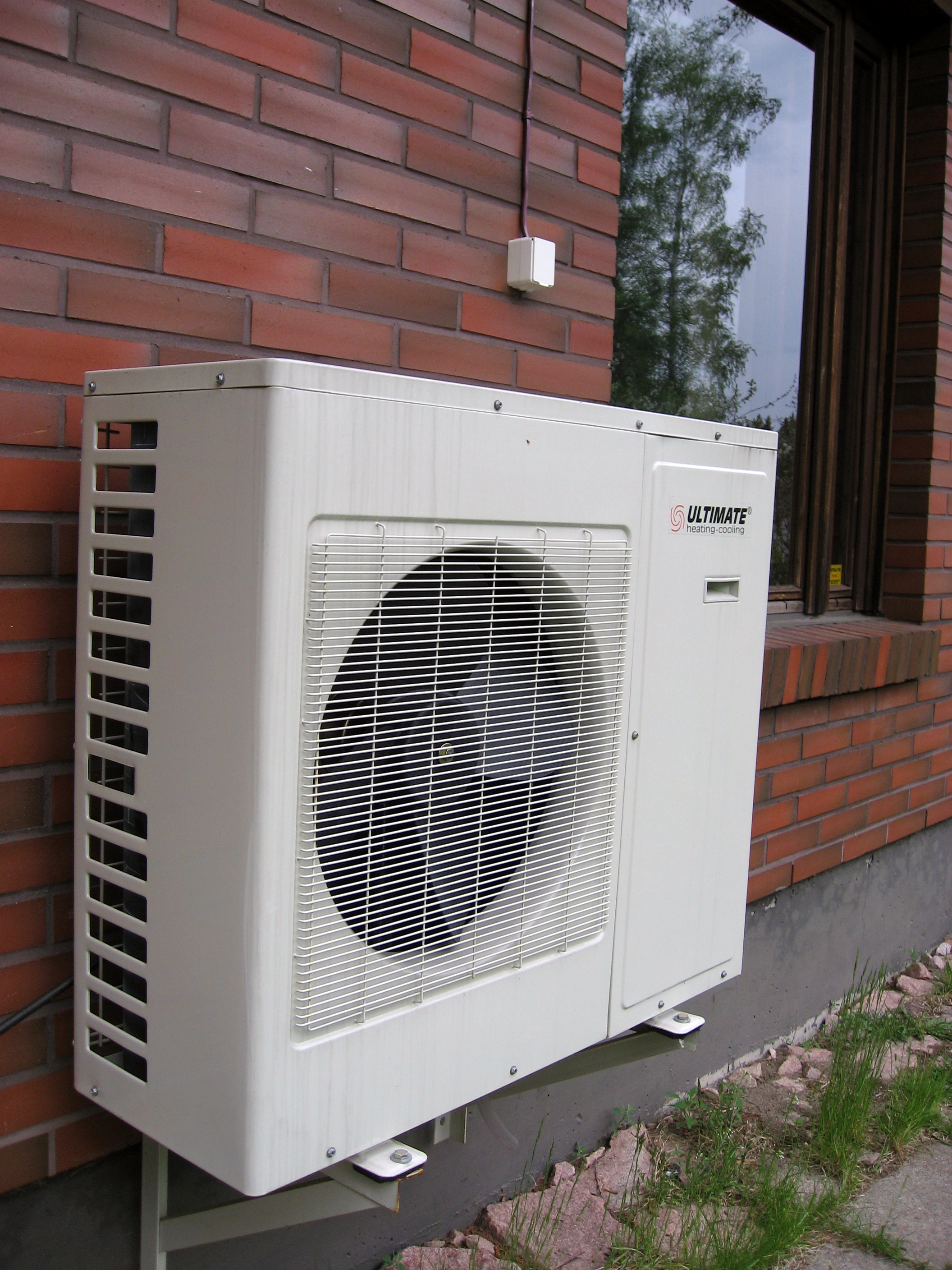 Heat pump on outside wall of house