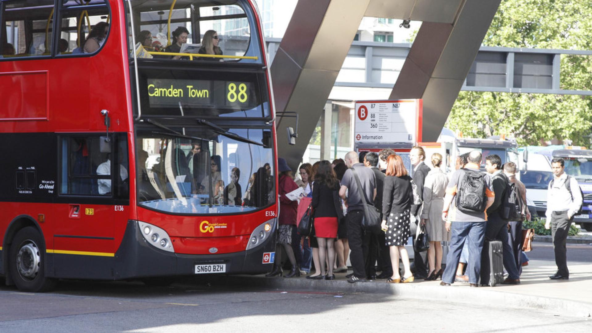 People queuing to get on a London bus