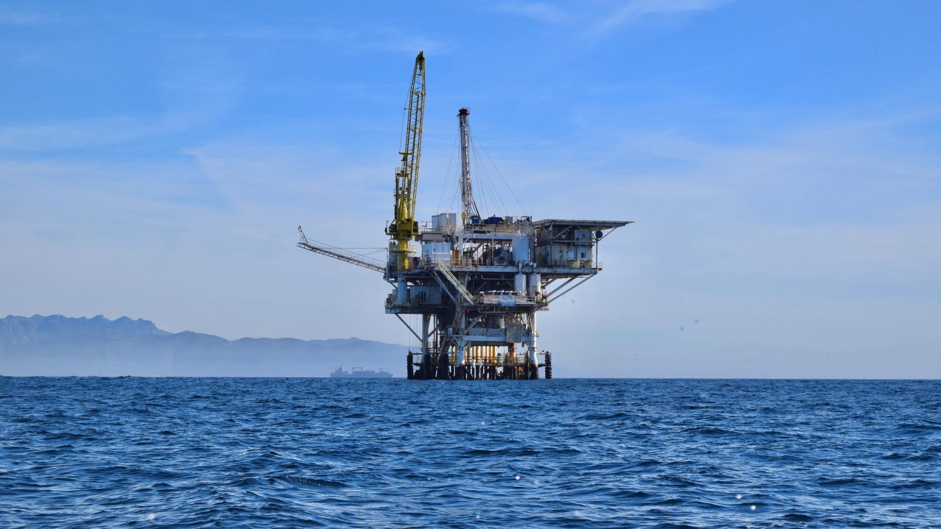 Offshore oil rig in the middle of a blue ocean