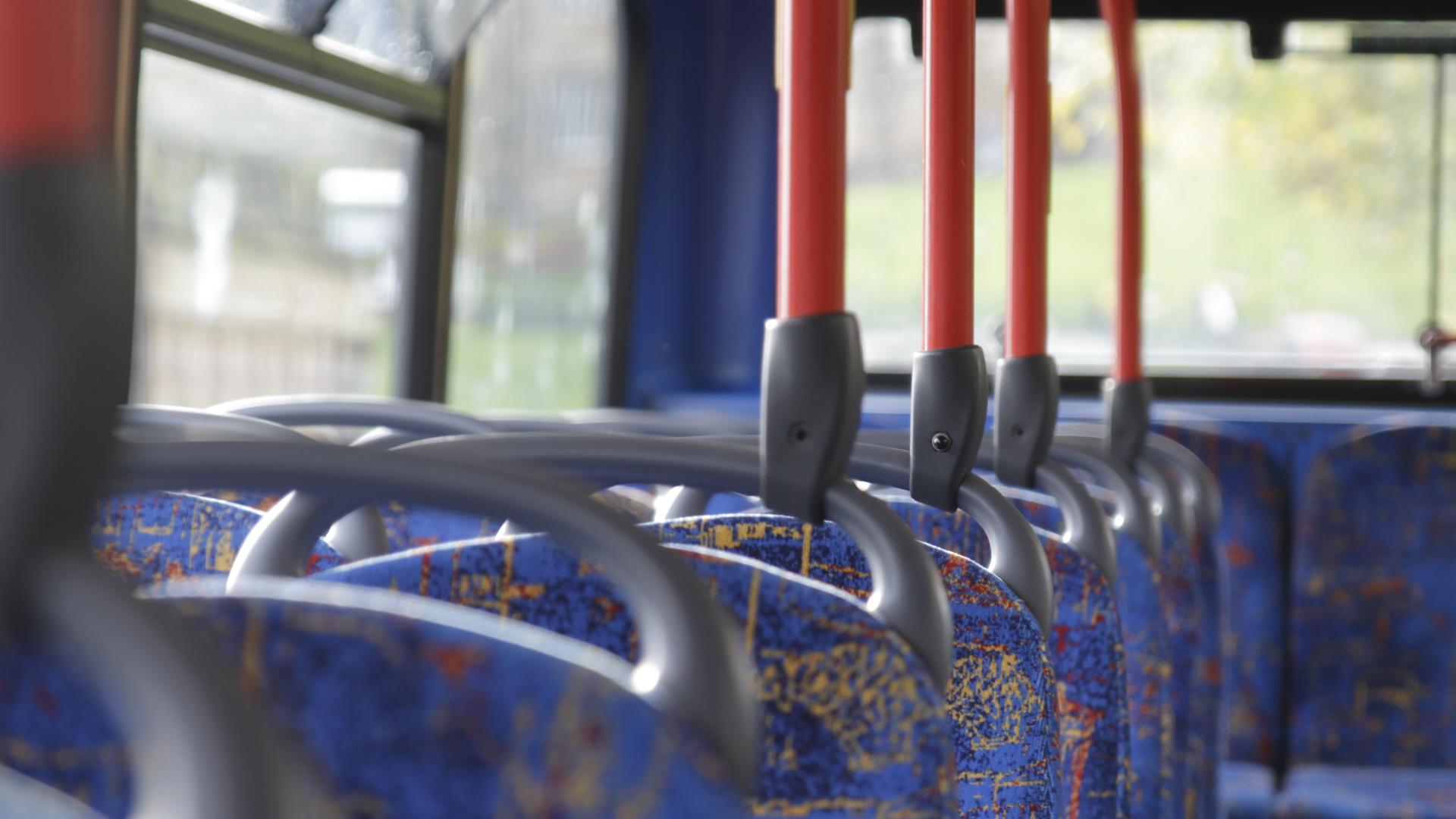 A line of empty seats on a bus
