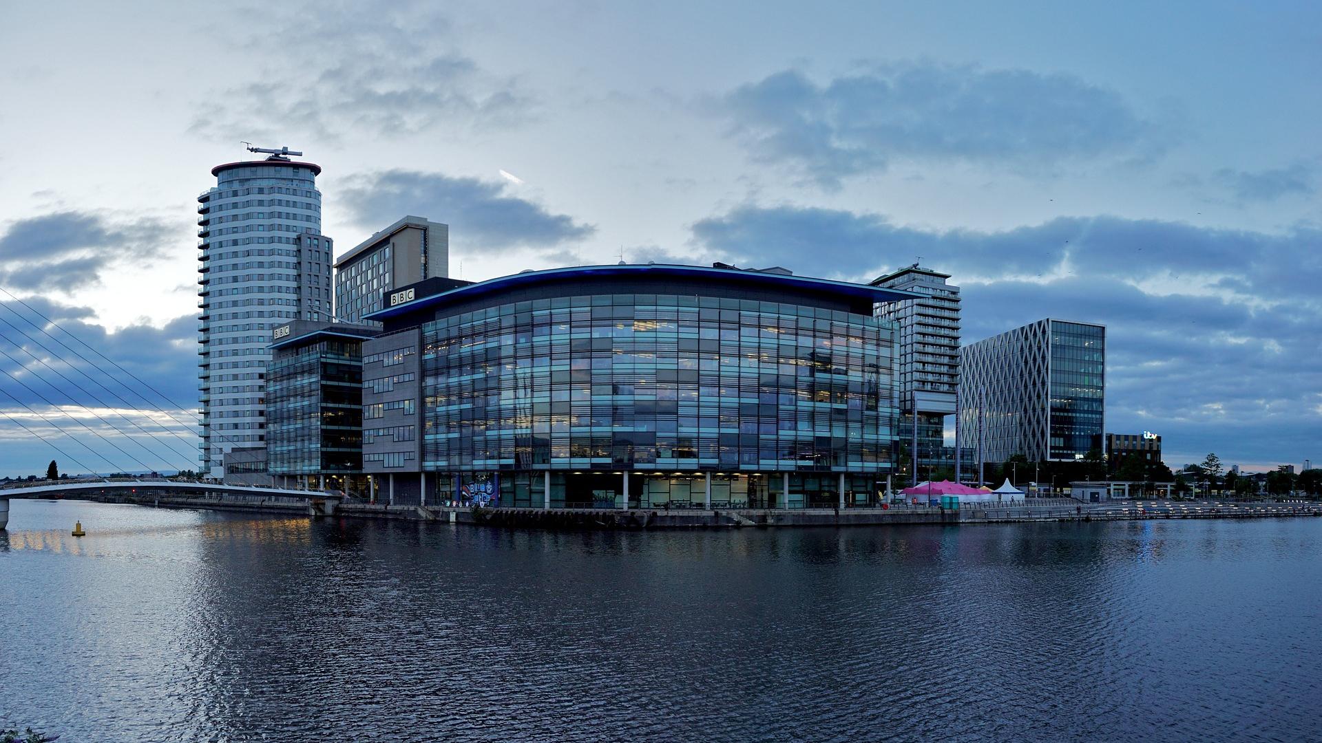 View of modern buildings across a stretch of water, Manchester