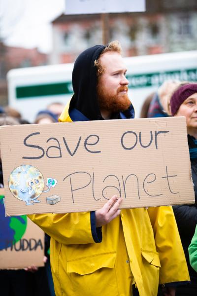 Climate protester holding home-made Save our Planet placard
