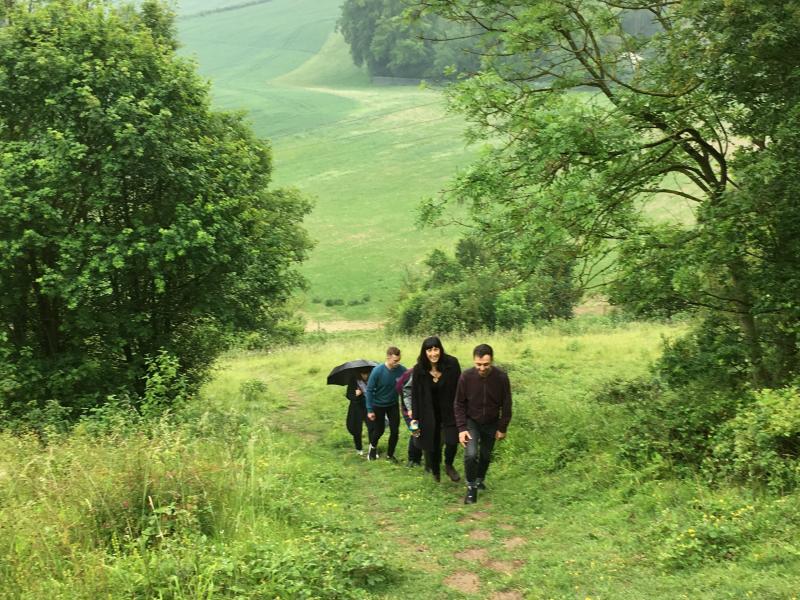 Group of people walking uphill in Kent's green belt