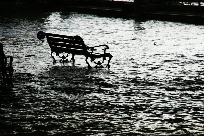 Park bench surrounded by flood water