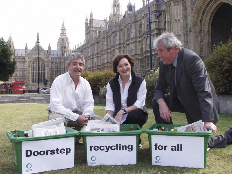 Tony Juniper, Joan Ruddock MP and Elliot Morley MP kneeling beside green boxes, Houses of Parliament in background