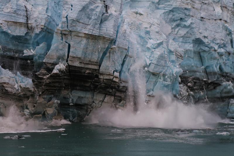 Ice melting from glacier with water pouring into the sea