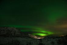 Aurora Borealis – the northern lights over snowcapped peaks