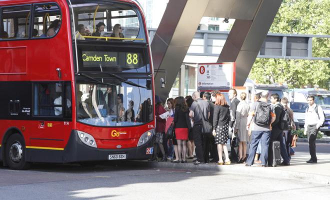 People queuing to get on a London bus