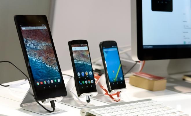 A display of smartphones plugged in and standing upright