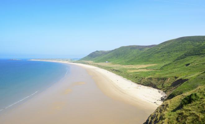 The beach and coastline of the Gower Peninsula at Rhossili Bay in Wales
