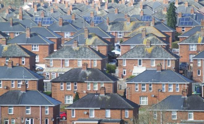 View of roofs of houses closely packed together, urban sprawl