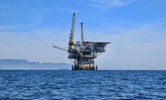 Offshore oil rig in the middle of a blue ocean