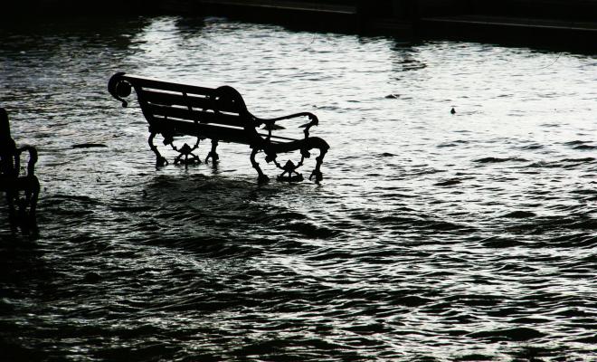 Park bench marooned in flood water