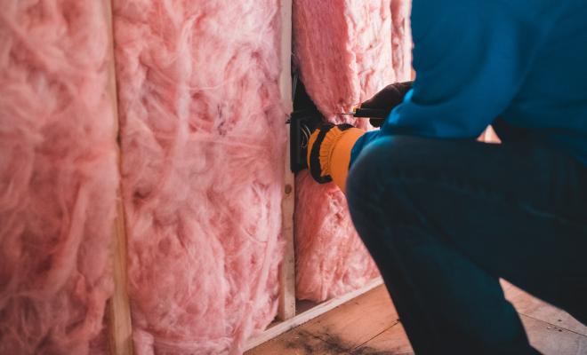 Man installing home insulation