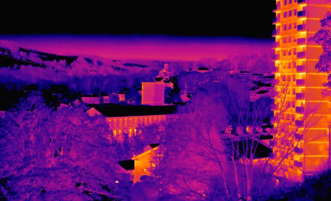 A landscape of Halifax using thermal imaging, with hot areas depicted in red and orange, and cold areas depicted in blue, purple and black.