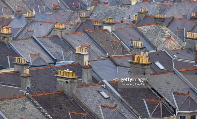 Rooves of terraced houses, several with chimneys