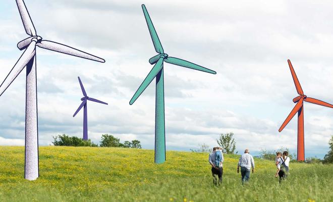 People walking through a field with illustrated wind turbines